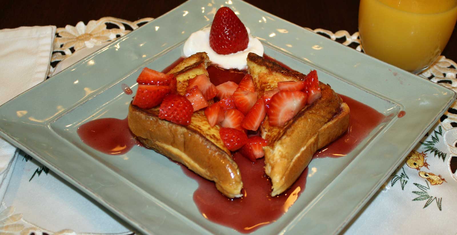 French toast with cream cheese filling, topped with diced strawberries and sauce